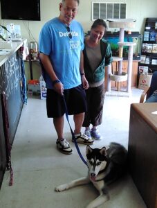 Adopters with dog at a shelter