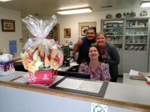 vet hospital staff with fruit gift basket